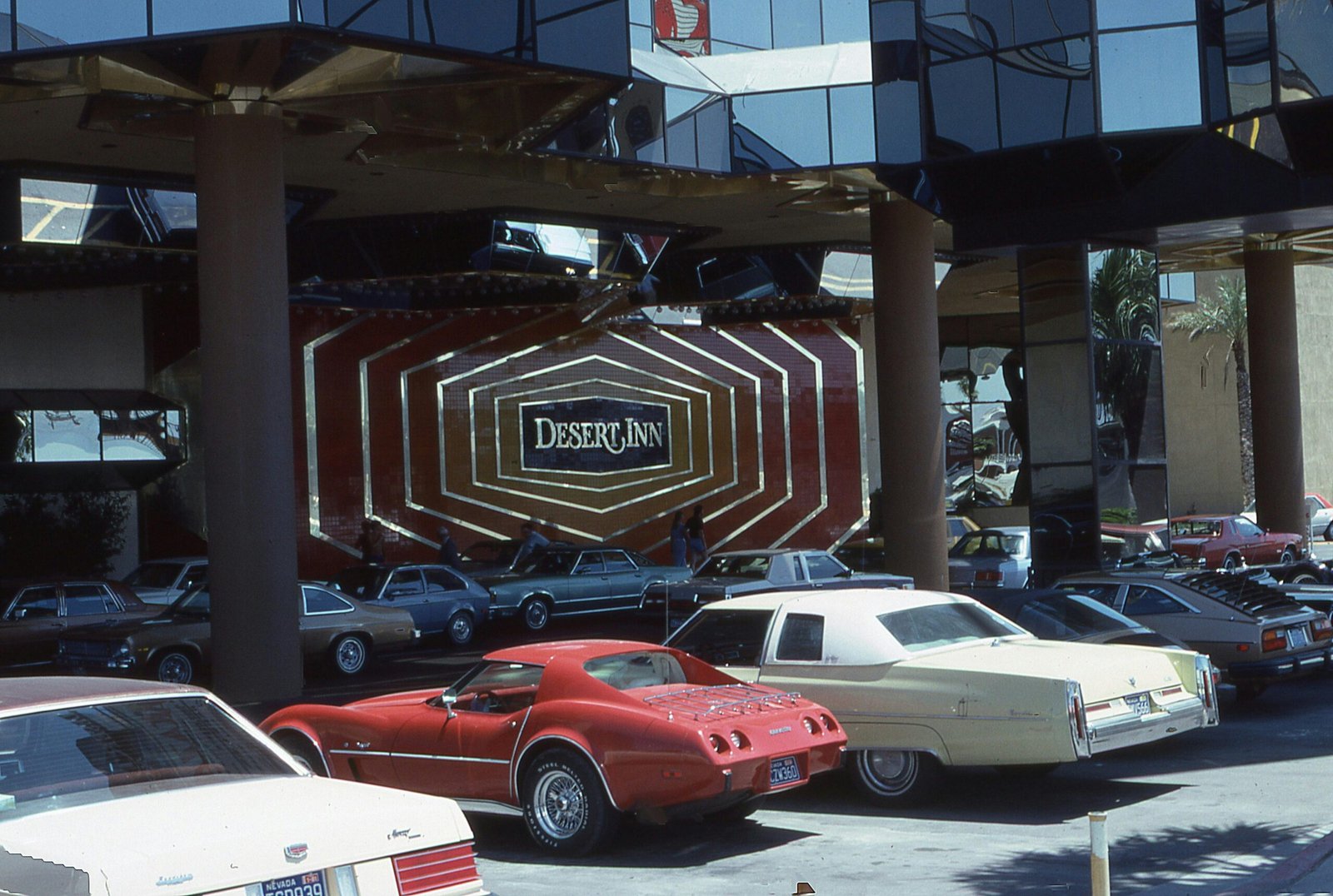 Classic cars parked in front of the Desert Inn Hotel showcasing luxury and style.